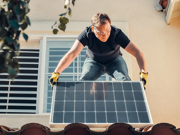 Man Handling solar panel